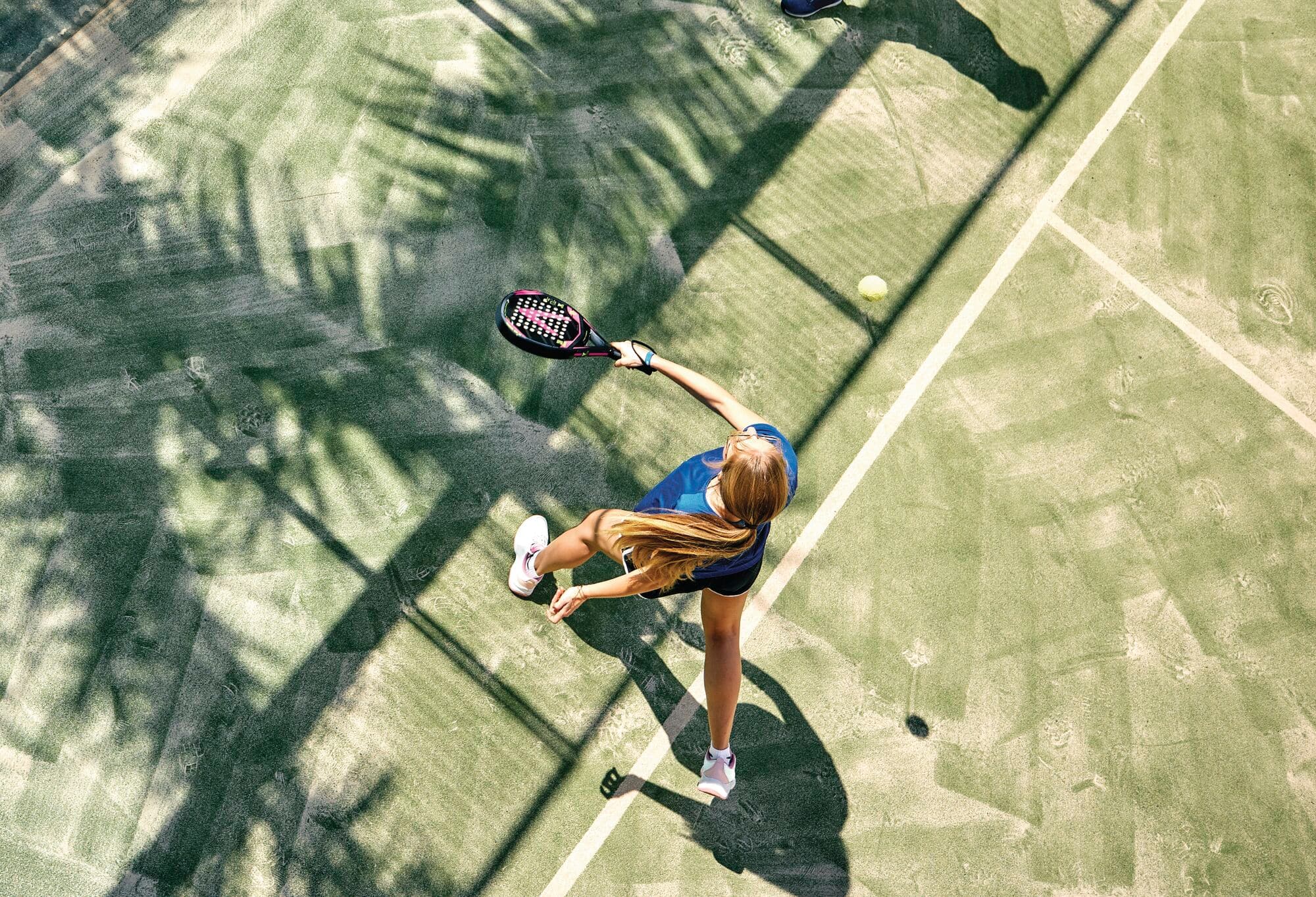 A topdown view of someone playing padel.