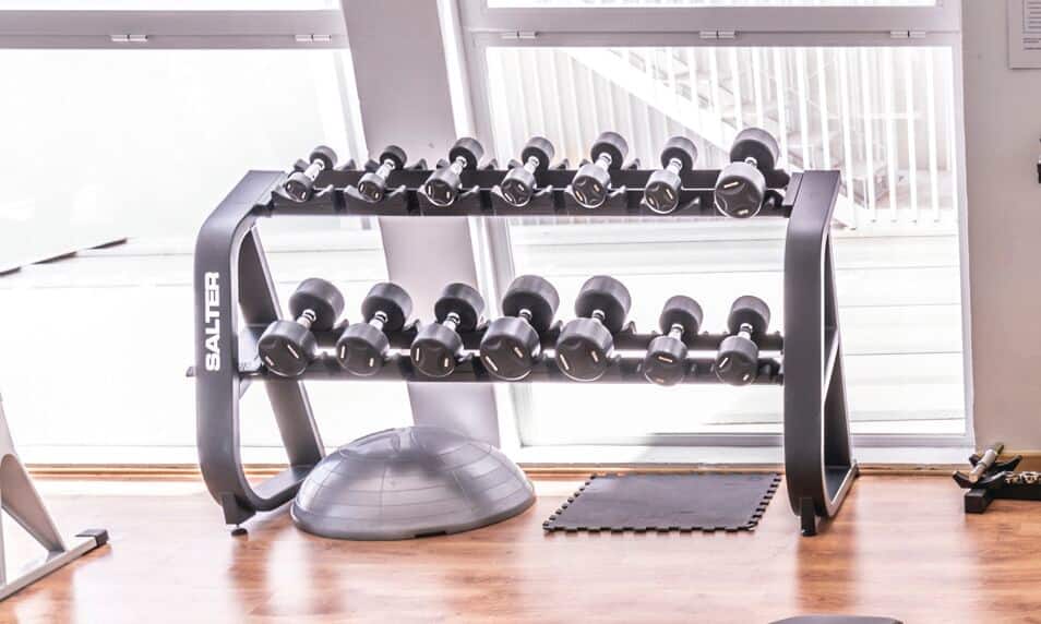 A row of free weights at a gym.