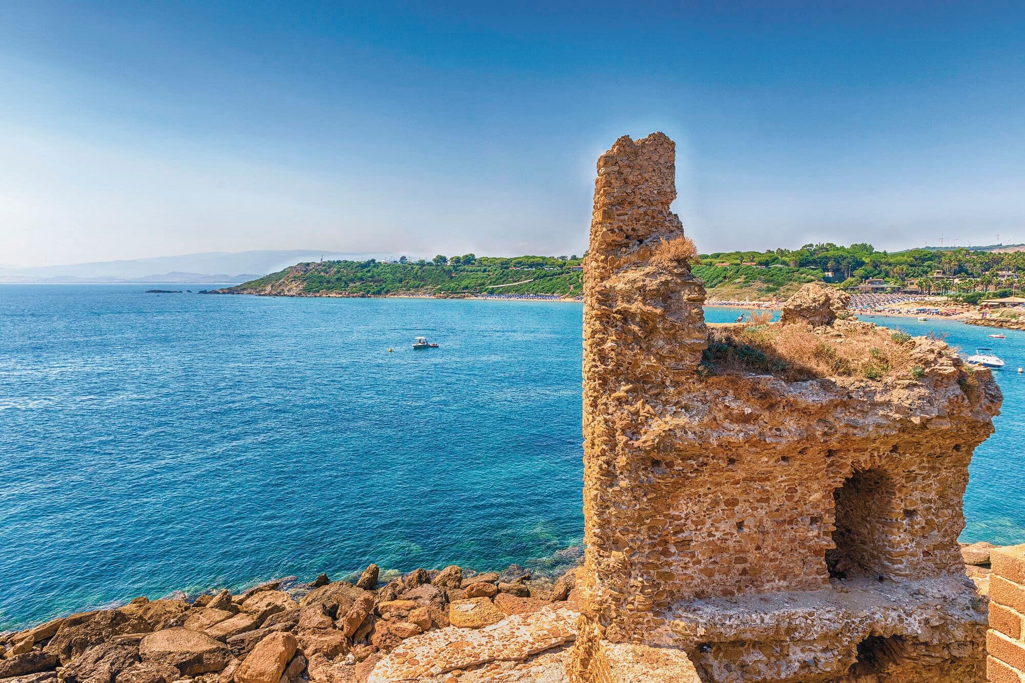 Looking along the coast, with a ruined tower in the foreground