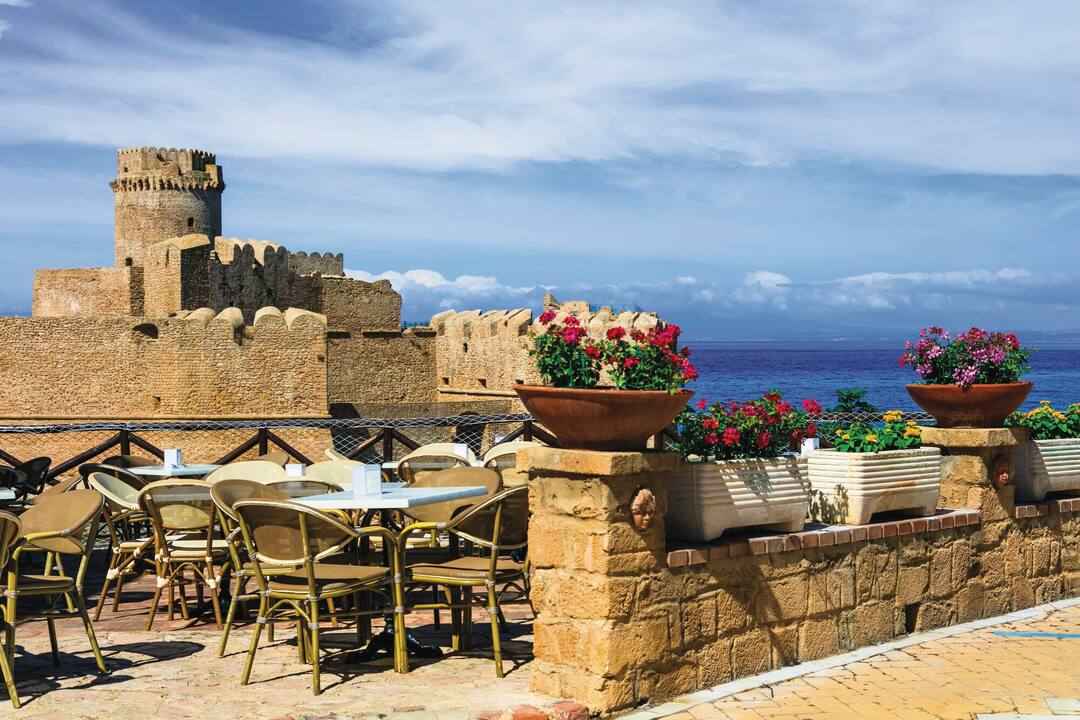 A restaurant terrace with a view of the castle