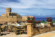 A restaurant terrace with a view of the castle