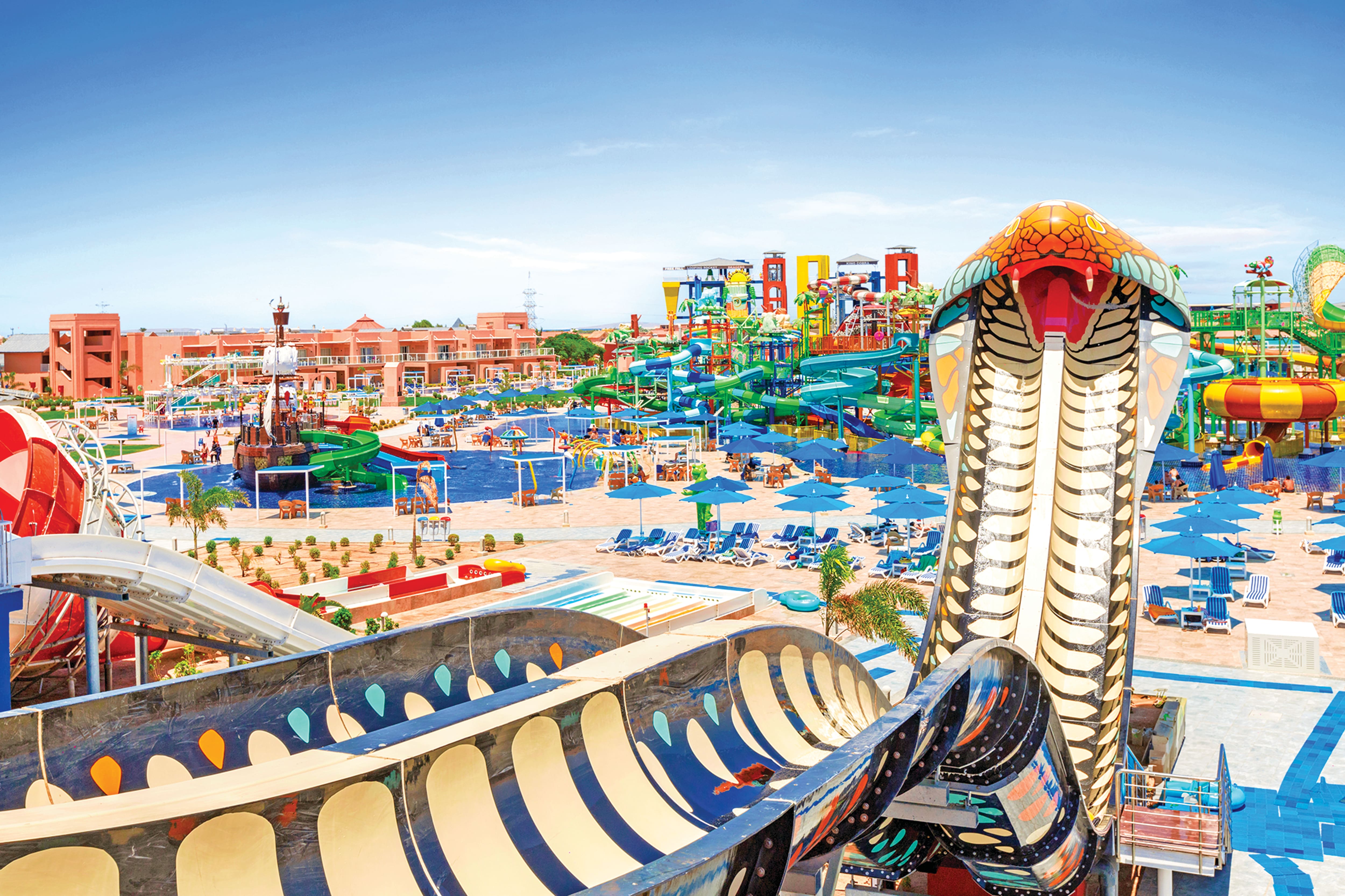 A water park with a cobra-themed slide in the foreground.