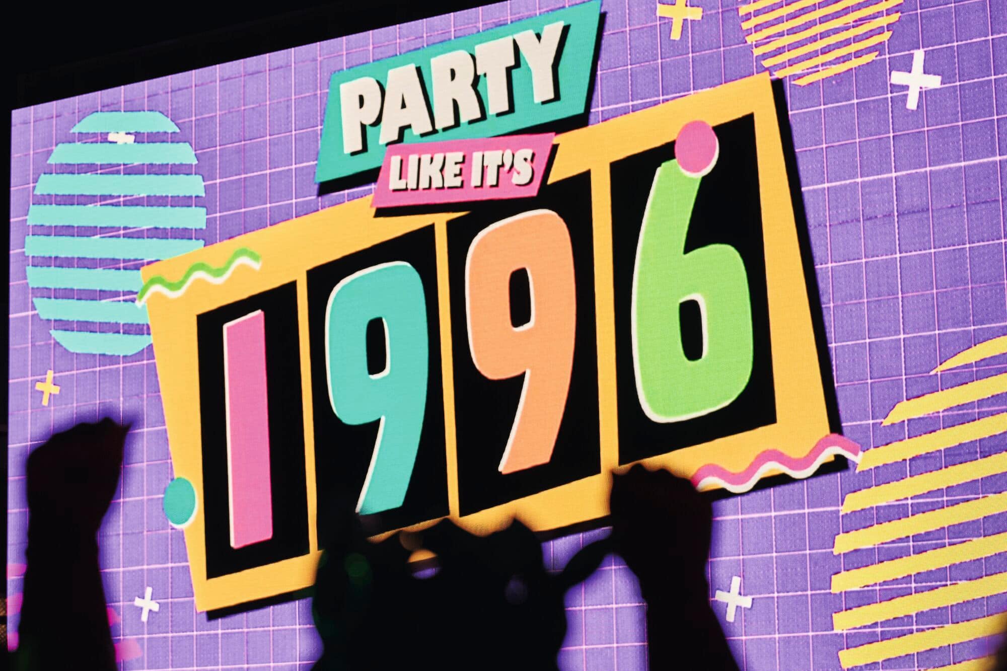A retro neon sign that says "Party like it's 1996".