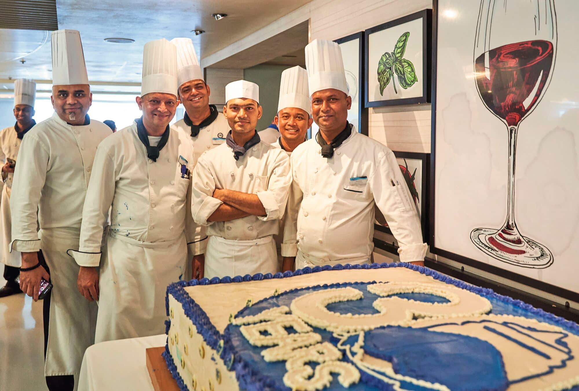Chefs showing off a 30 year birthday cake. 