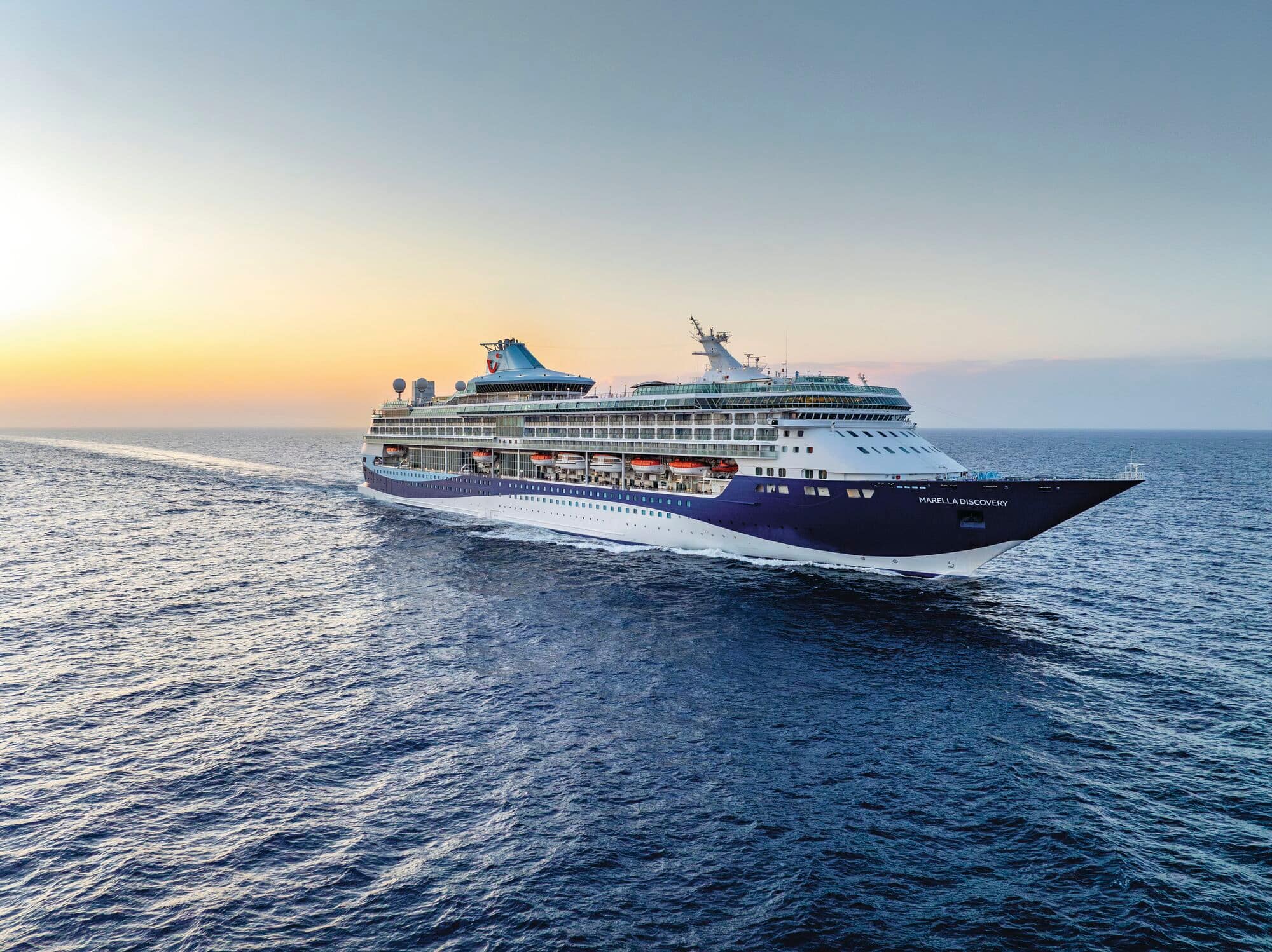 A Marella cruise ship at sunset.