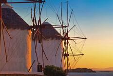 A close up of the windmills at sunset