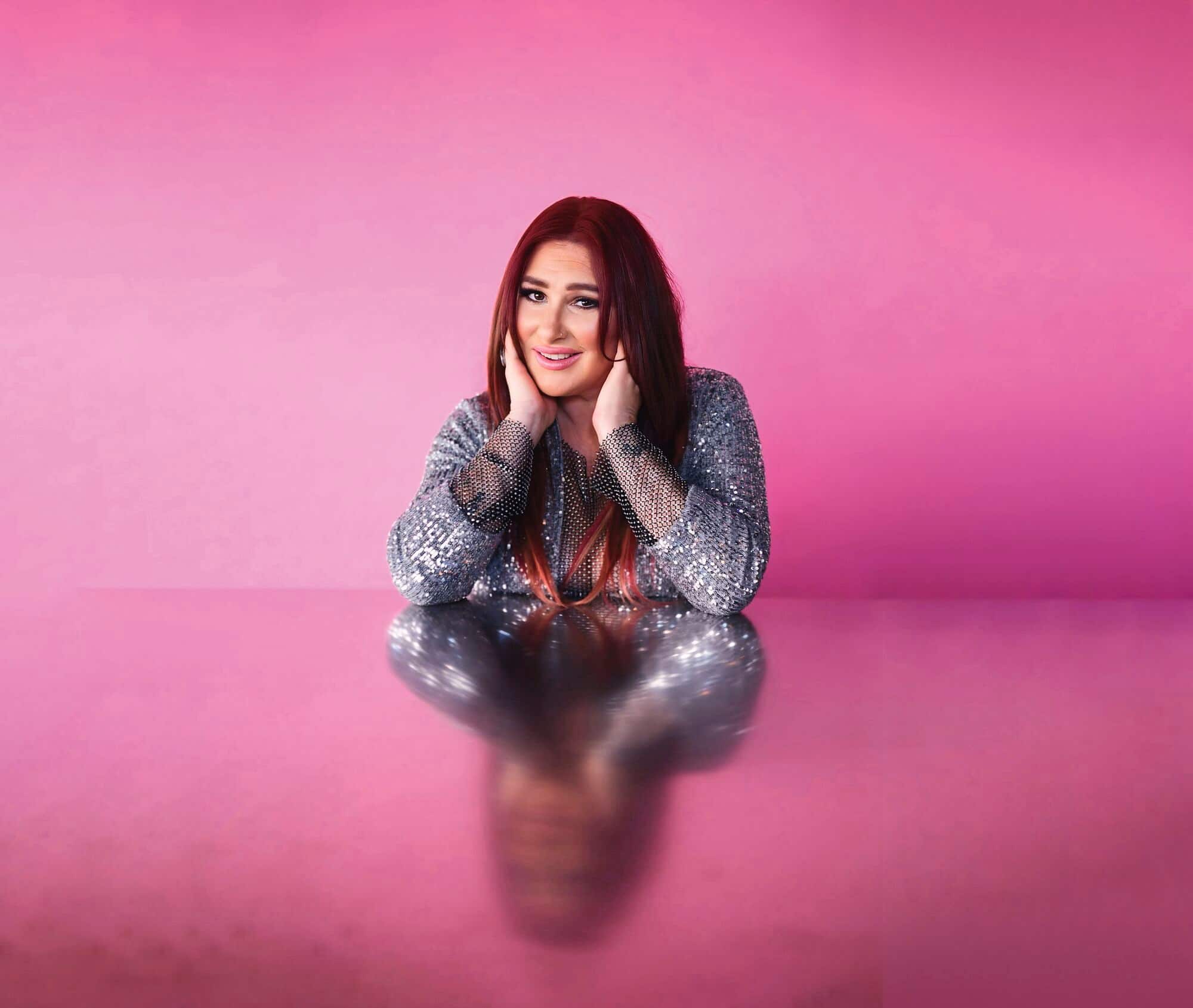 Tiffany in front of a pink background.