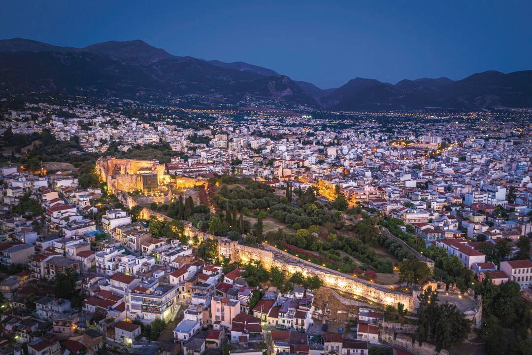 An aerial view of Patras, illuminated at dusk