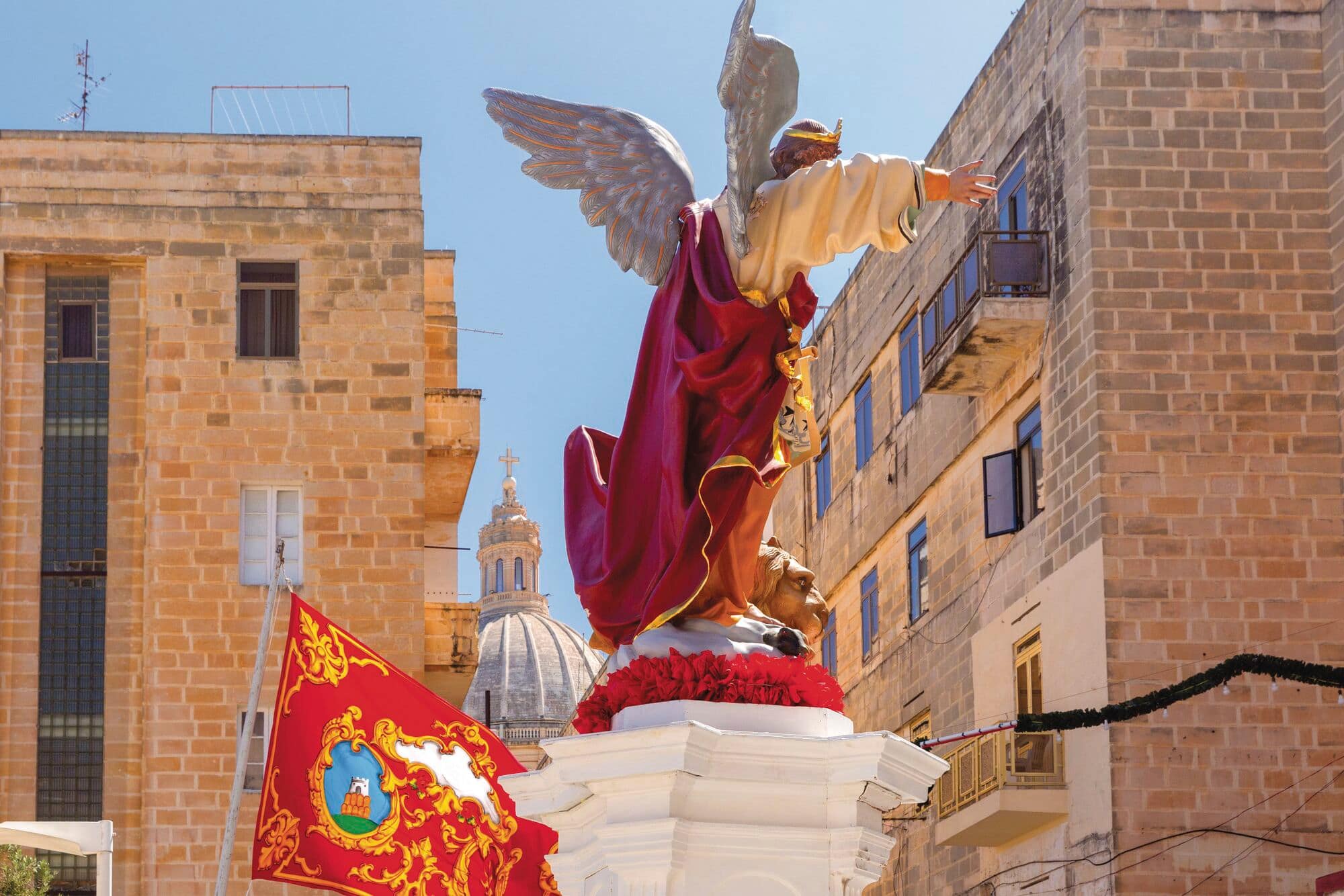 A painted statue of an archangel in Valletta, during the celebrations