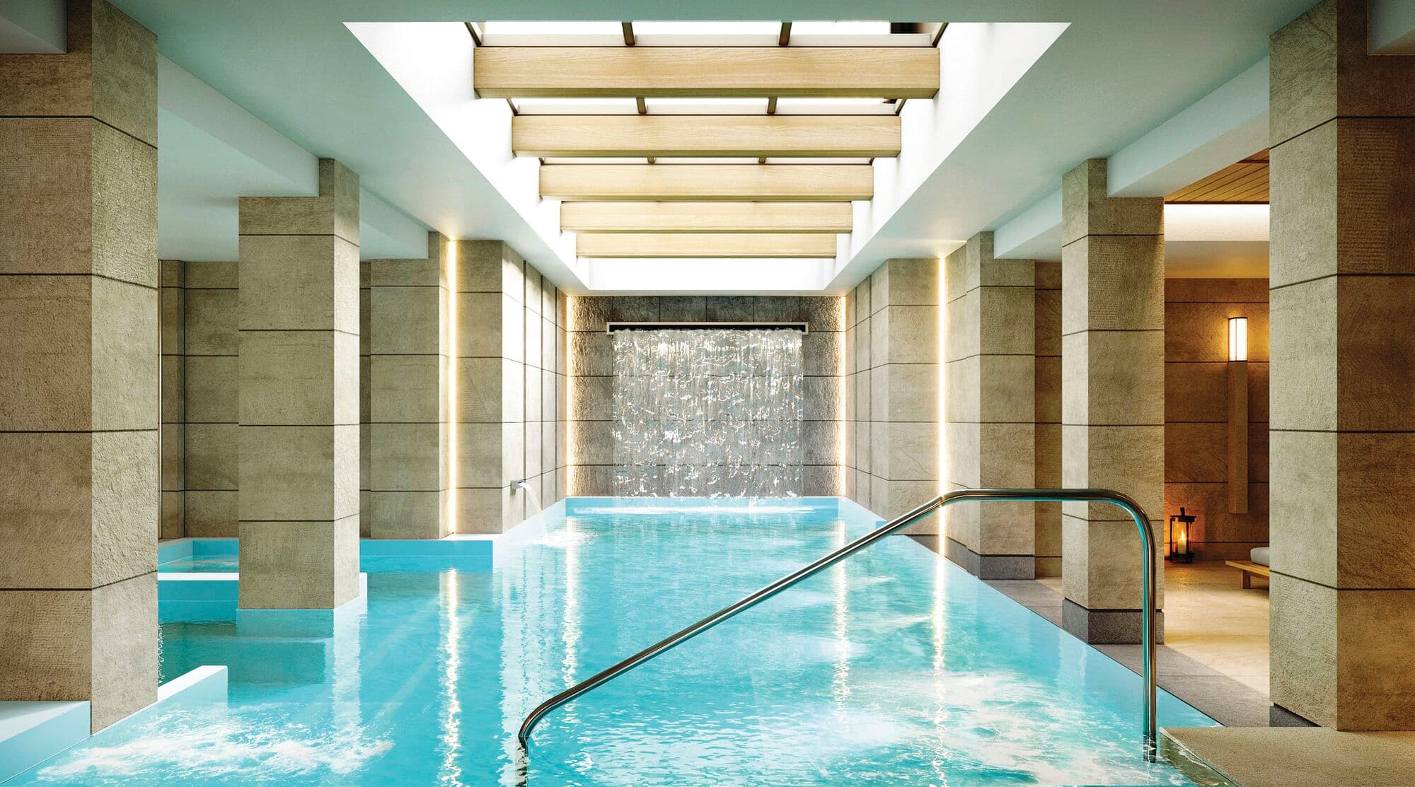 An indoor spa pool with waterfall feature and modern relaxation area at Electra Kefalonia Hotel & Spa.