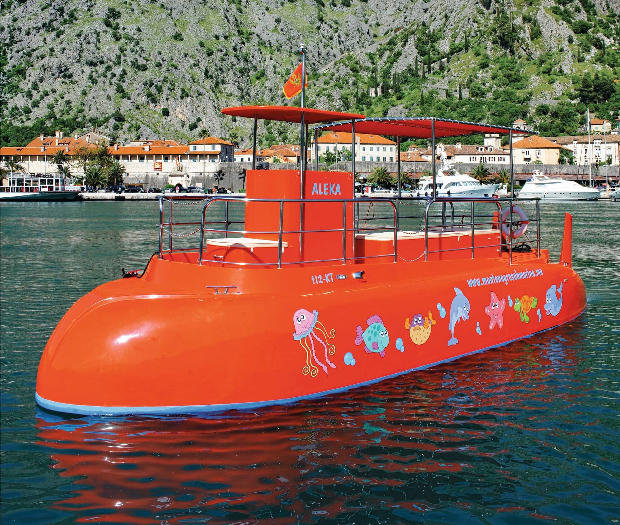 An orange submarine slightly submerged in the water.