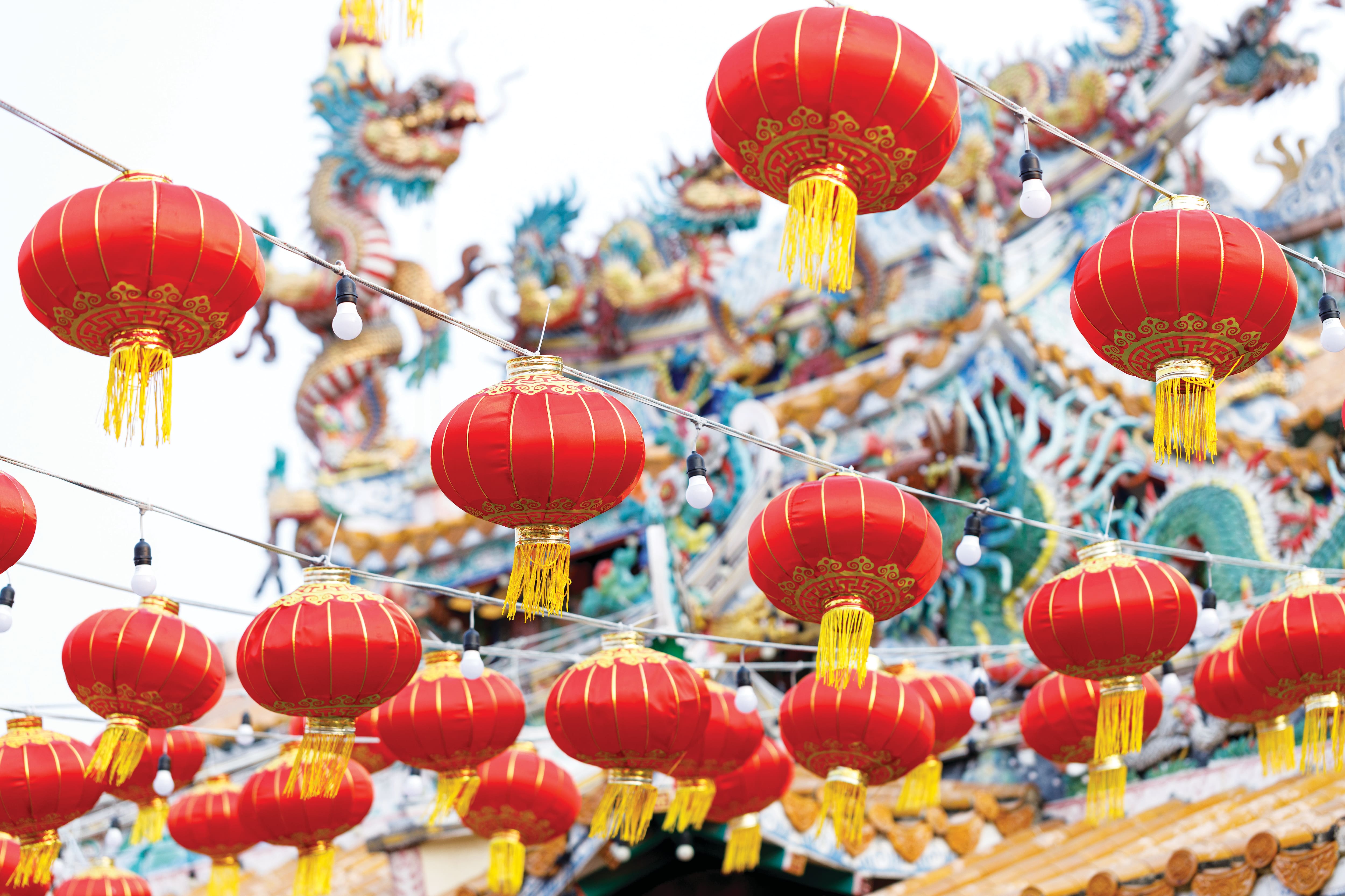 Red Chinese lanterns on a string hanging as outdoor decoration
