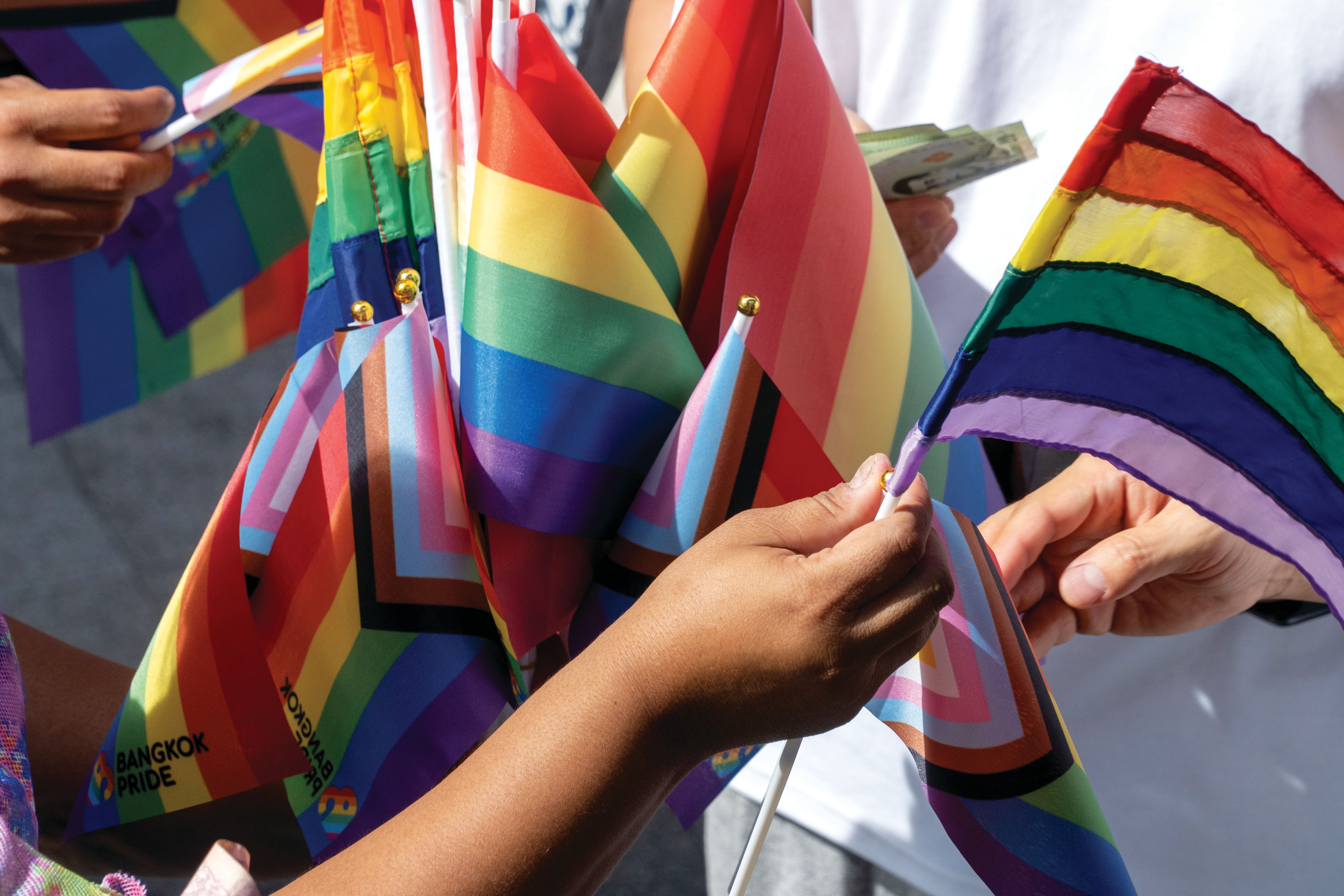 Rainbow flags being handed out at a Pride event. 