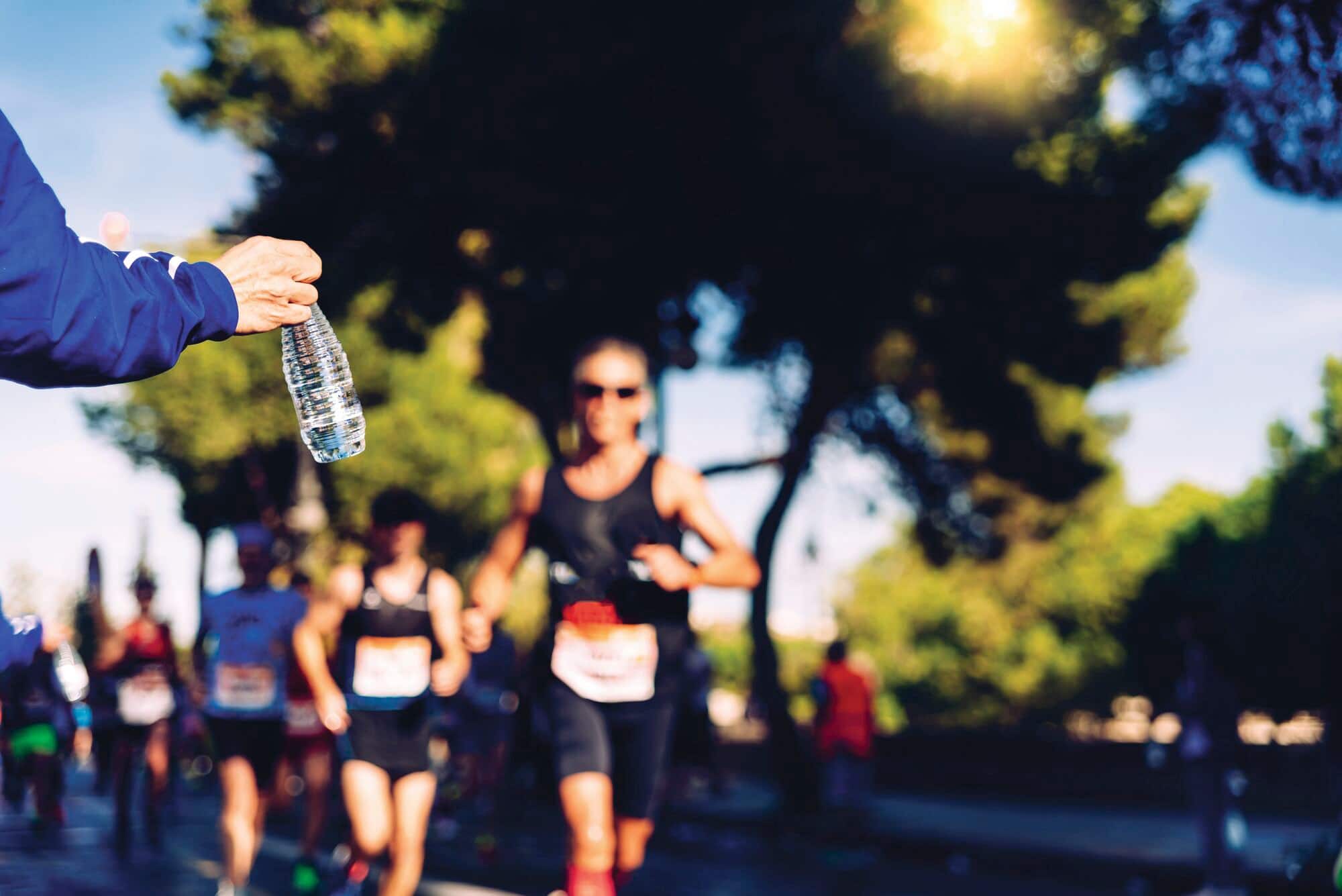 Runner collecting a bottle of water during a run