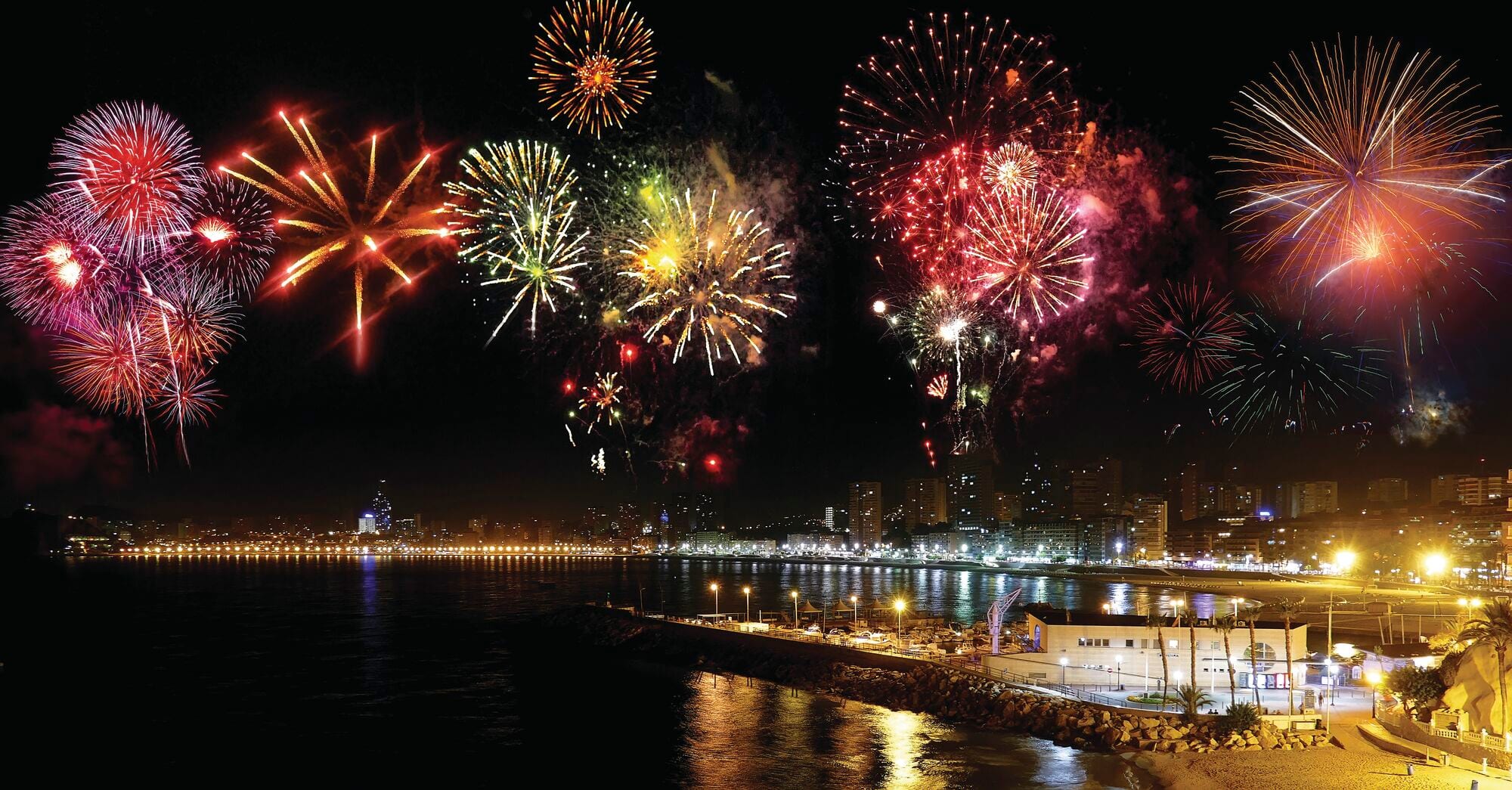 Fireworks lighting up the night sky above Benidorm’s seafront and city skyline.