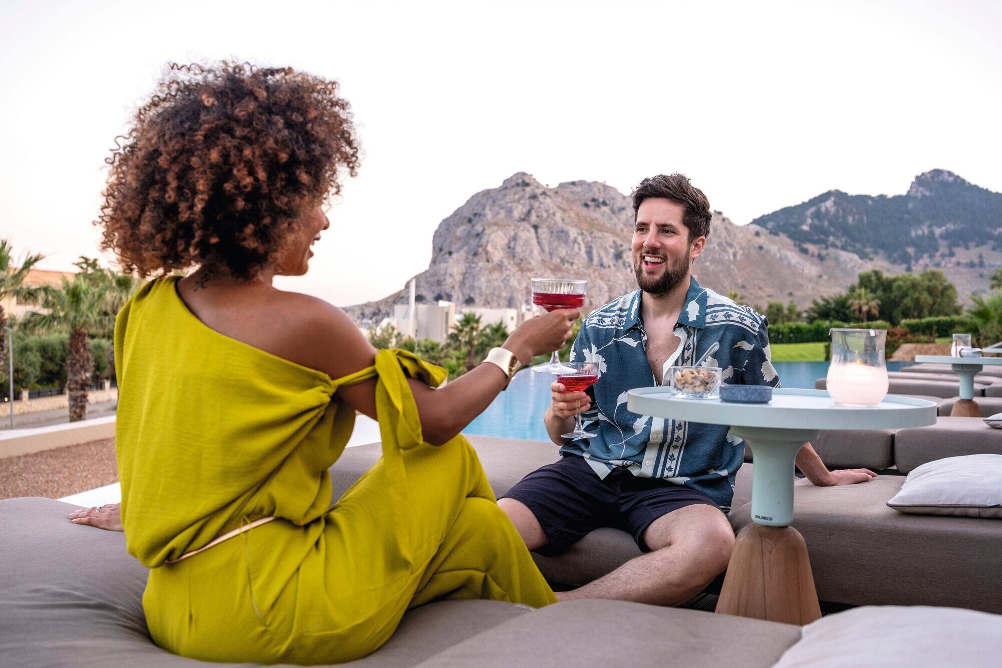 Couple having cocktails and hotel resort.