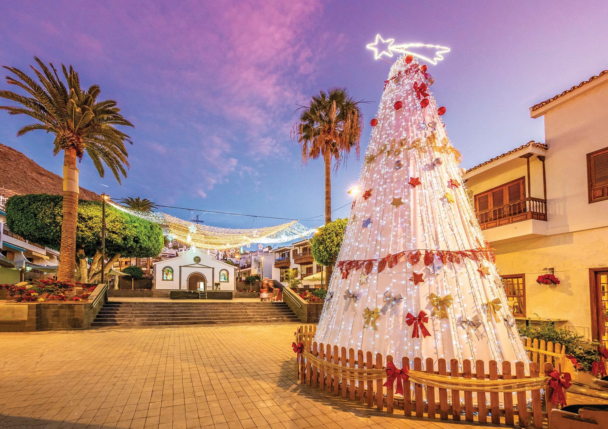 A white Christmas tree in front of a market in Puerto de Santiago, Tenerife.