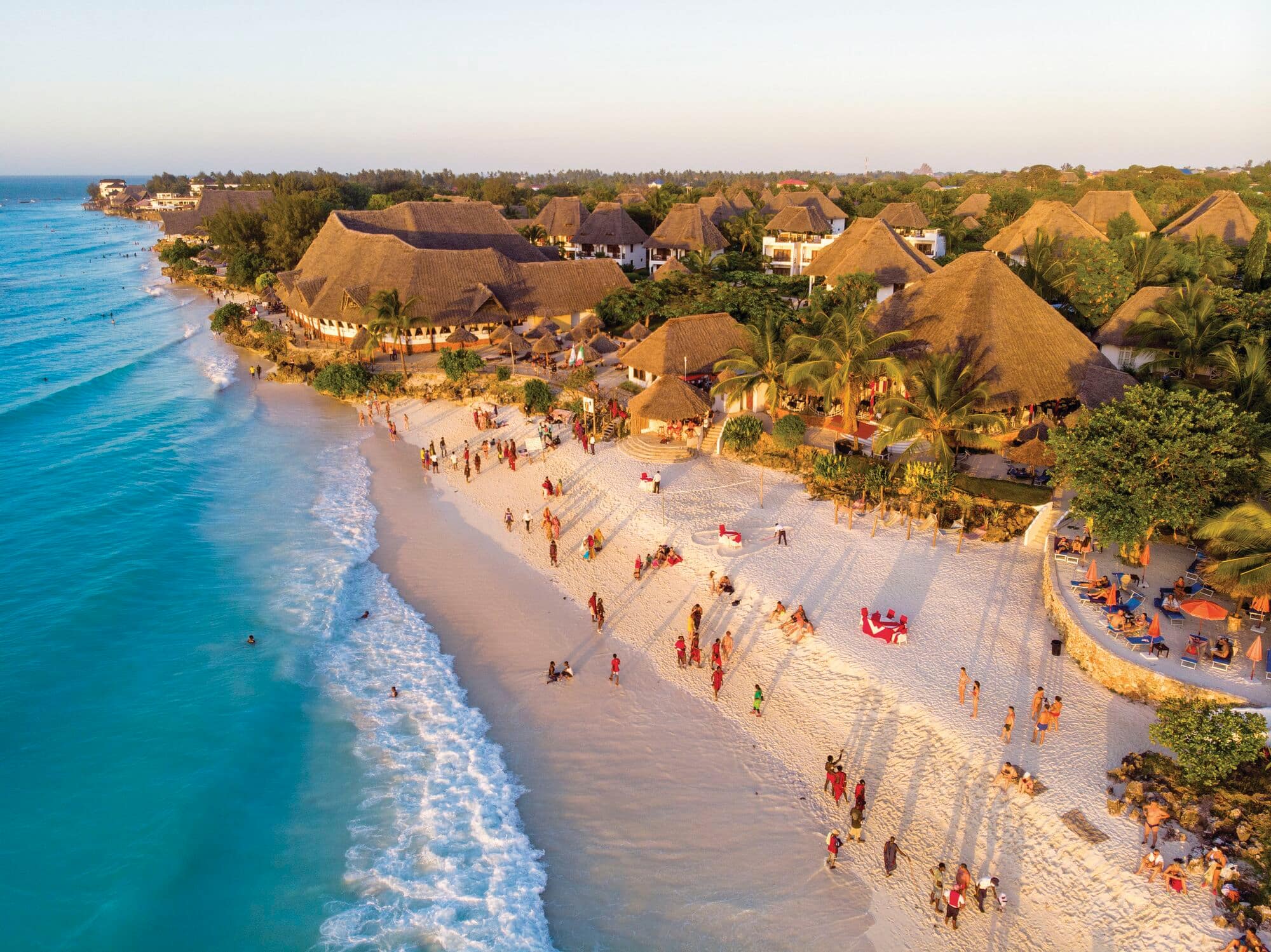 Aerial shot of people walking on the Nungwi beach in Zanzibar.