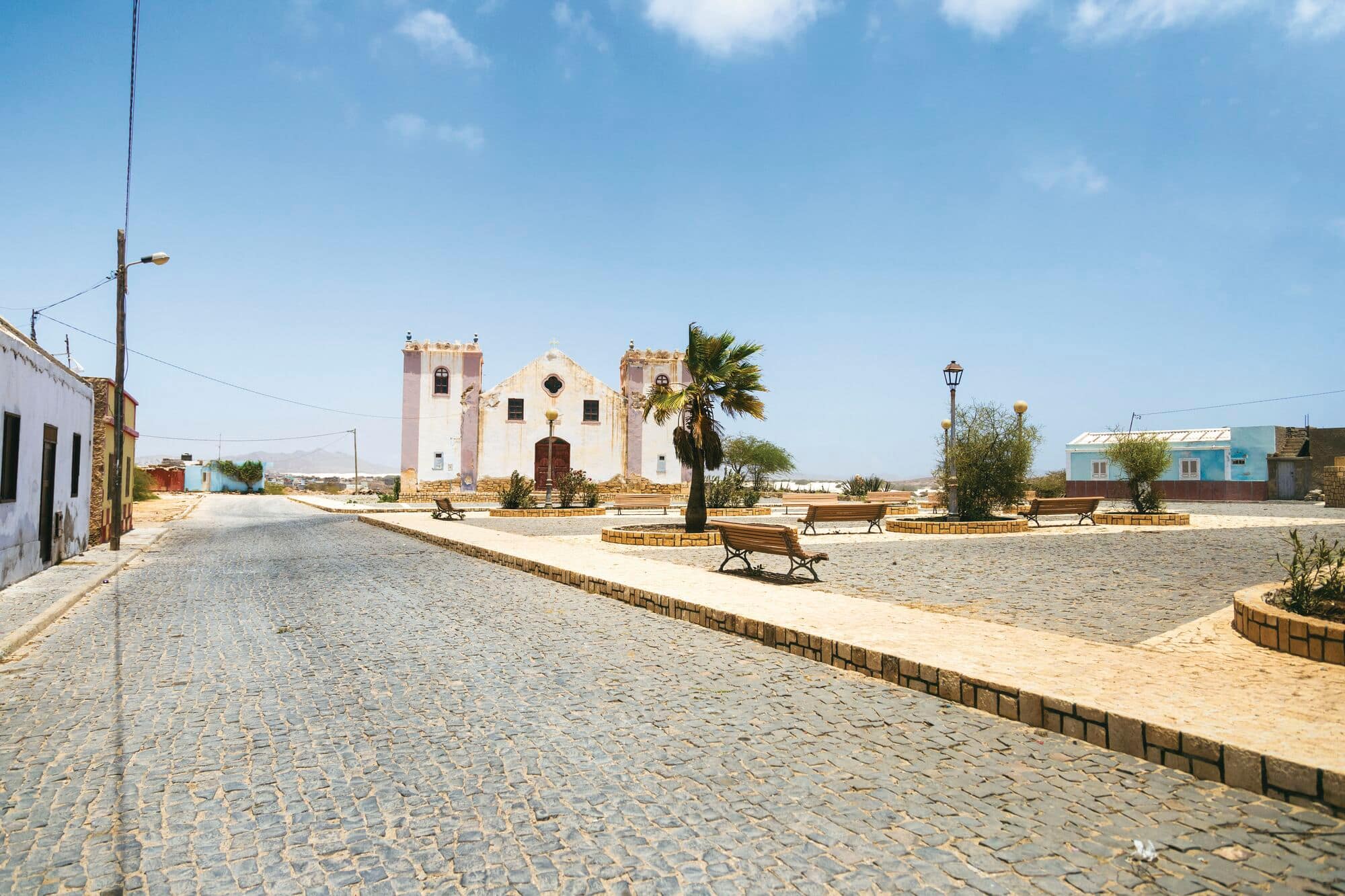 Church in a sunlit village square.