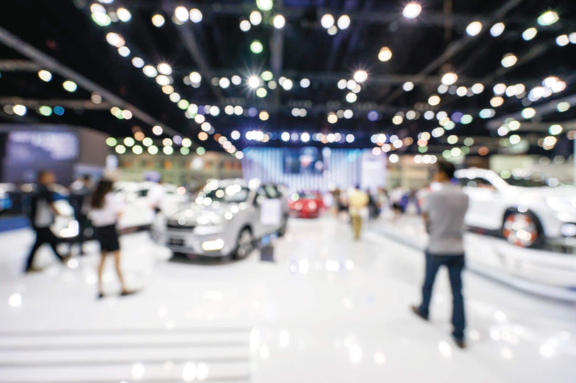 A blurred image of an auto show, for illustrative purposes