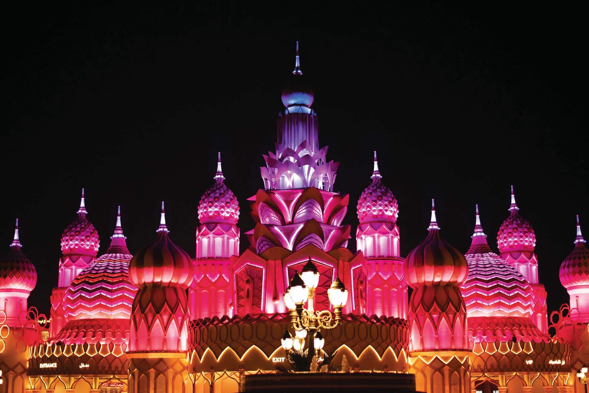Brightly illuminated entrance gate at Global Village in Dubai