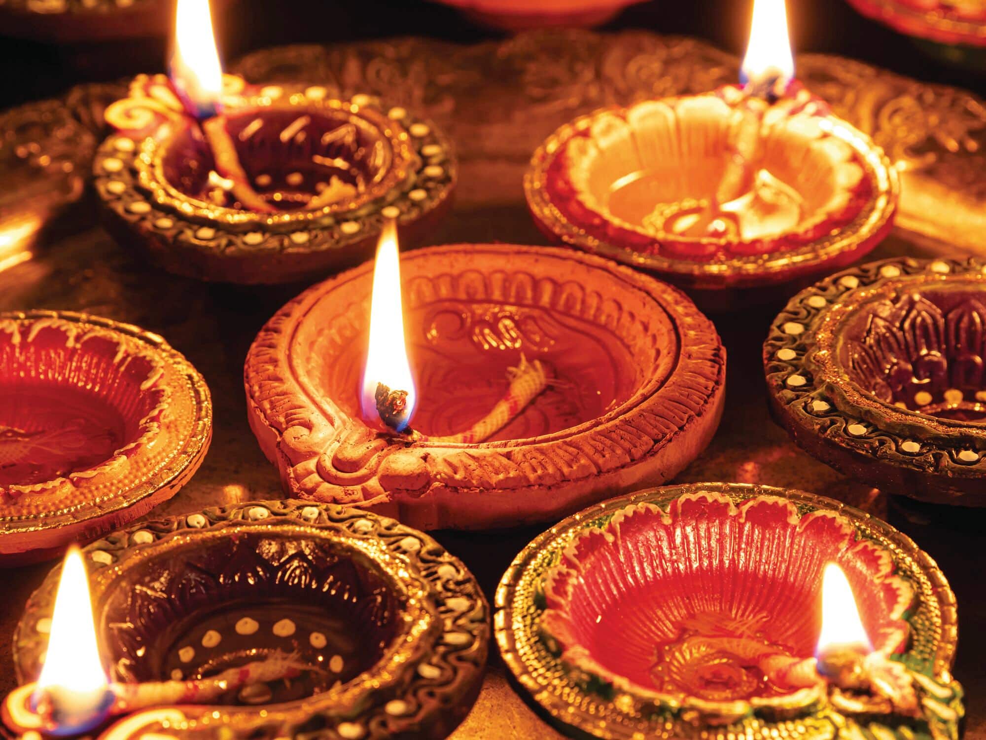 Lit decorative oil lamps arranged for a Diwali celebration.