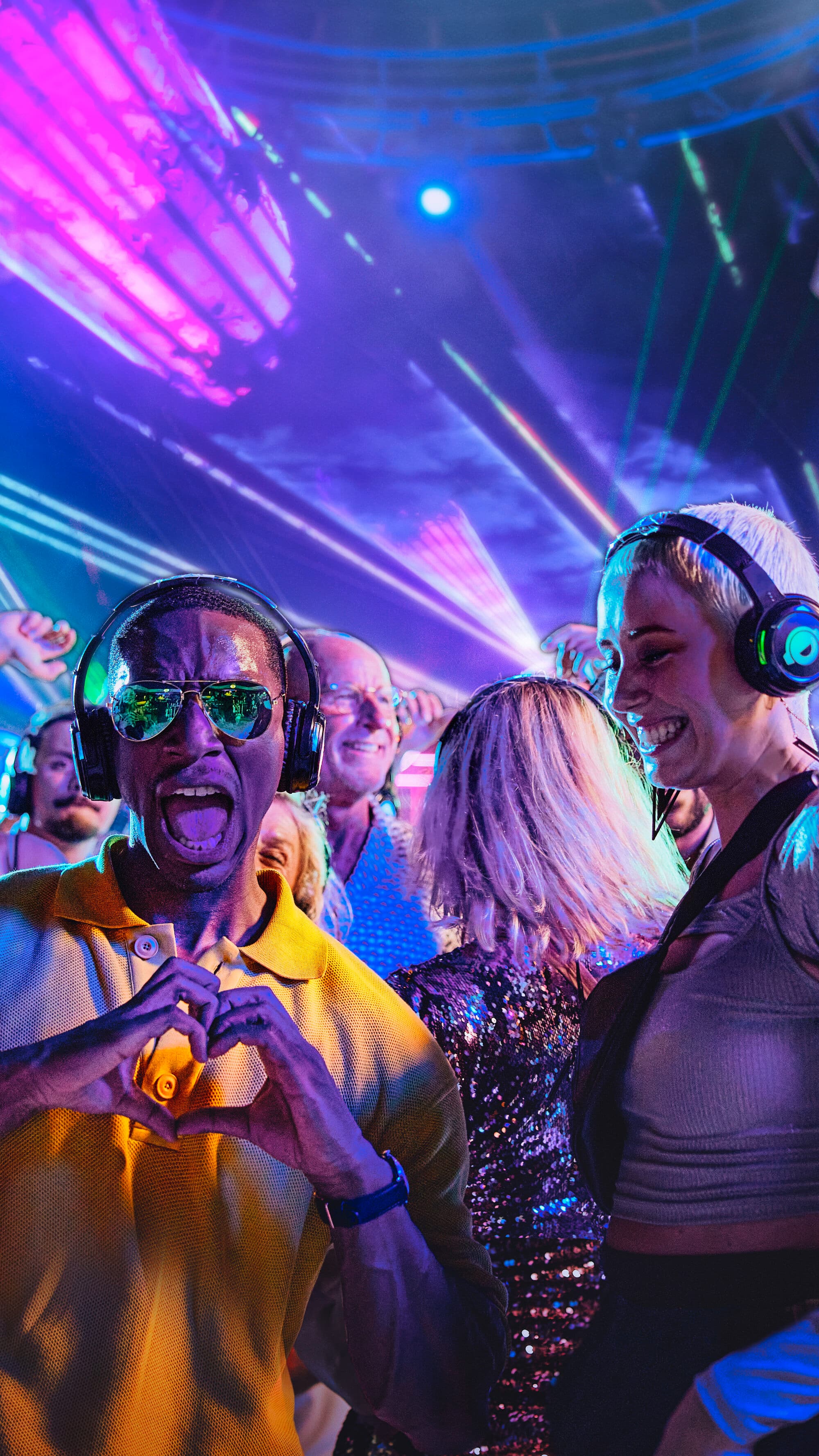A crowd in a nightclub enjoying a silent disco.